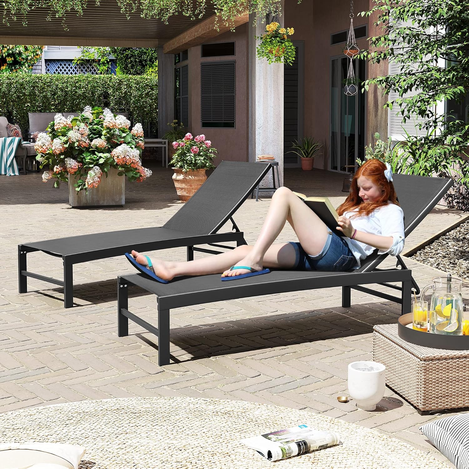 Black aluminum chaise lounge chair with five-position adjustable backrest, shown on beach or patio setting โ view 5