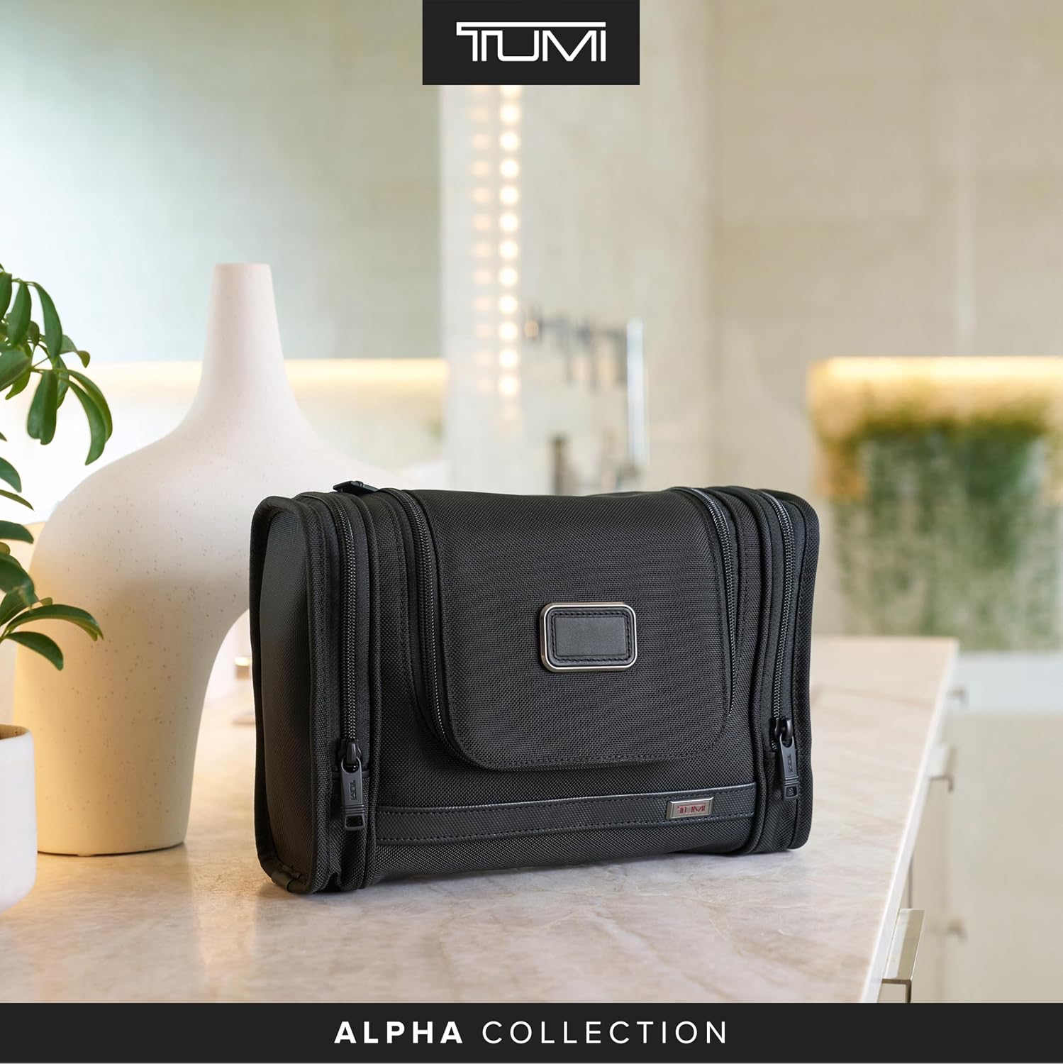Black hanging toiletries organizer with multiple compartments and hook attachment, displayed flat — view 5