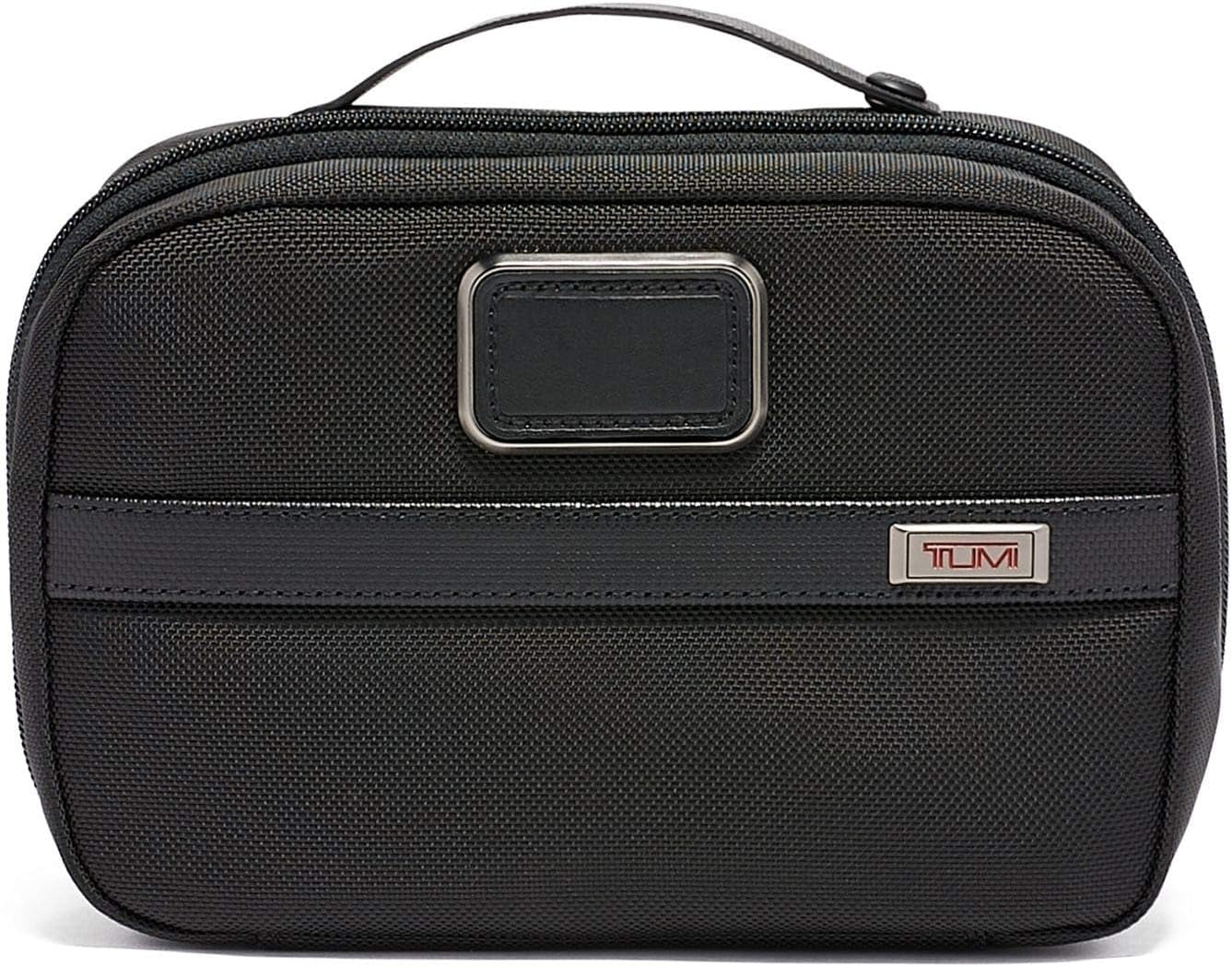 [Color] compact toiletry bag with removable leather handle and multiple zip pockets, shown open displaying organization compartments — view 1