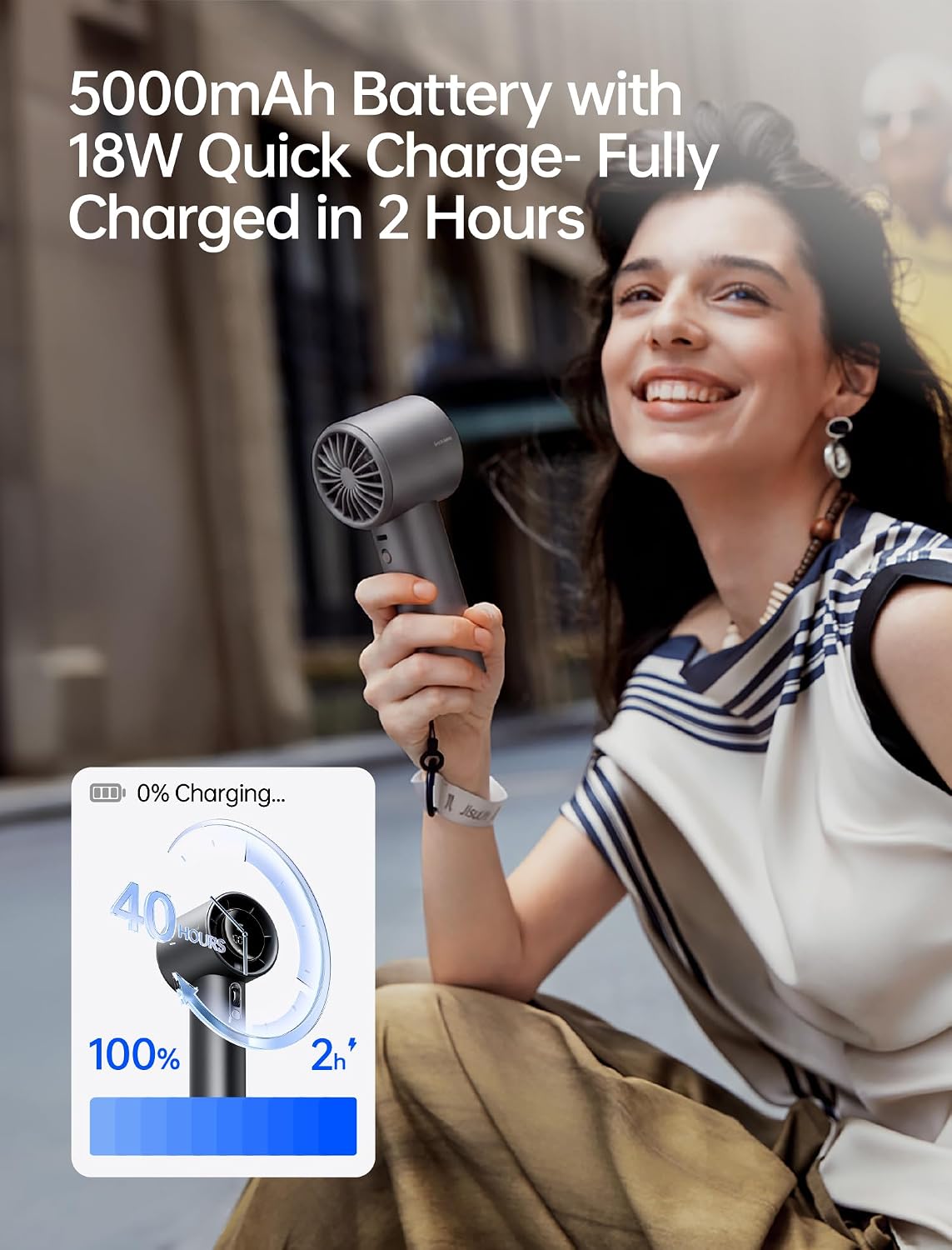 Compact metal handheld fan in [color] with variable speed dial, shown from front angle displaying cooling feature — view 4