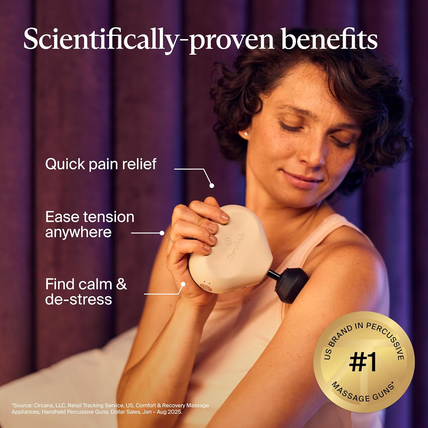 [Color] compact portable massage gun with aluminum body and silicone grip, displayed on travel luggage — view 2