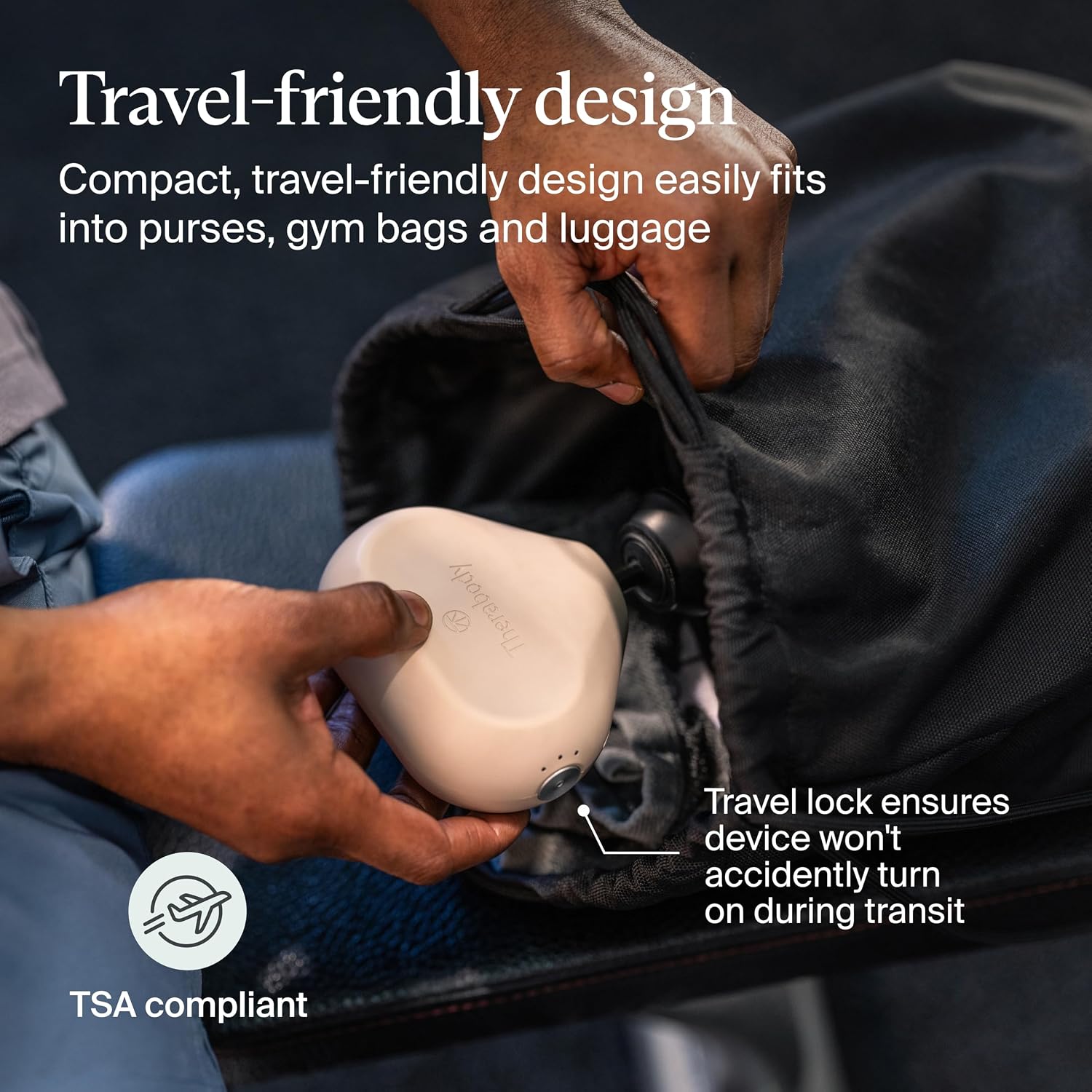 [Color] compact portable massage gun with aluminum body and silicone grip, displayed on travel luggage — view 4